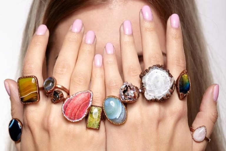 How to wear rings: woman wearing a colorful ring on each finger