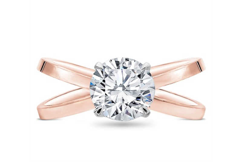 Criss cross engagement ring setting with round cut diamond