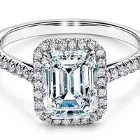 Emerald cut halo engagement ring with a diamond platinum band