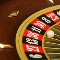 Roulette wheel in casino settles on black number 11 -or